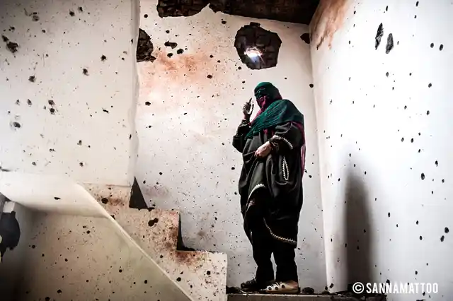After the Chattabal encounter that killed three militants and a civilian, a woman looks at her house that also became a casualty on 5 May 2018. 