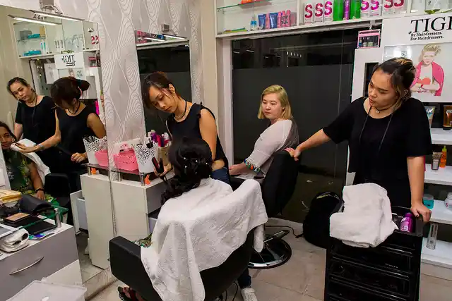 Amy Stacy, a hair dresser, and Sne Aribam, a makeup artist, engaged in work at a beauty salon in Kolkata.