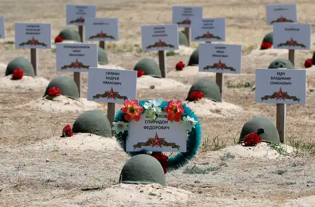 In this photo taken on Sunday, June 17, 2018, graves of Russian soldiers in a cemetery near Stalingrad in Rossoshka, Russia.