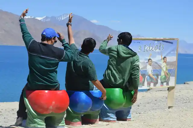 Three young boys emulating the title characters in the movie ‘3 Idiots’.