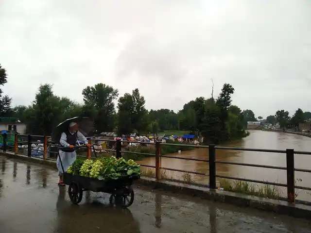 An onlooker glances at the Jhelum river in south Kashmir’s Anantnag, where an alert was sounded on Friday.