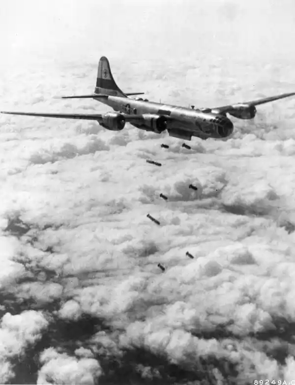 Husky 1,000-pound demolition bombs hurtle from this US Far East Air Forces B-29 “Superfort” of the 19th Bomb Group toward a Red target somewhere beneath the cloud layers in Korea, August 1951.