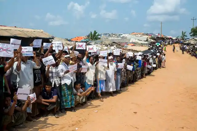 Rohingya refugees holding placards, await the arrival of a UN Security Council team in Bangladesh.