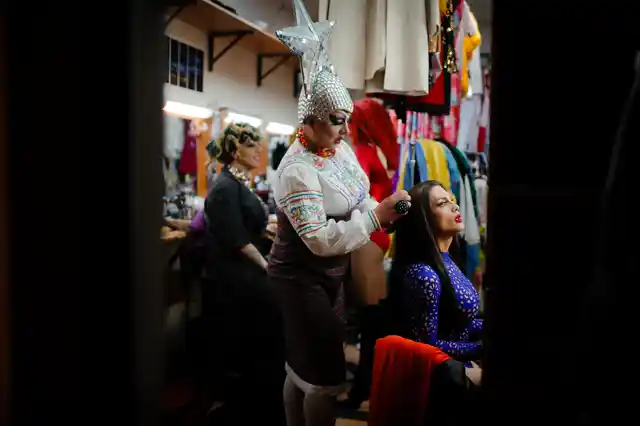 Sergey, who uses the stage name Bomba (the bomb) combs the hair of Andrei, or Star Vasha, right, as they get ready to perform at a Gay club during the 2018 soccer World Cup in Yekaterinburg, Russia.