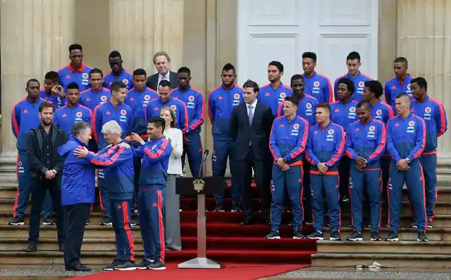 Colombia’s President Juan Manuel Santos, front row left, awards the Cross of Boyaca to national soccer team coach Jose Peterman, front row second left, during a ceremony outside the presidential palace in which the team was presented with the nation’s flag, in Bogota, Colombia on 24 May 2018. 