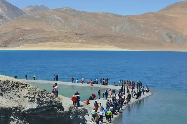 Pangong Lake, with its shimmering blue waters, spreads over 125 kilometres and has become immensely popular with Indian tourists since Bollywood movies <em>3 Idiots</em> and <em>Jab Tak hai Jan</em> were filmed in and around the lake in 2009 and 2012. 
