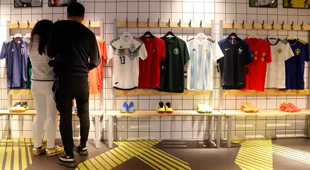 Customers look at different national soccer team jerseys that are on display at a shop in London. With just days to go before the FIFA World Cup, some winners and losers have emerged among the often wild and wacky team jerseys.