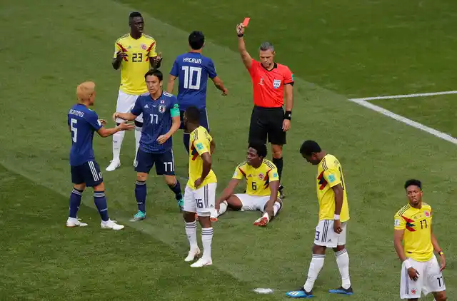 Referee Damir Skomina from Slovenia shows a red card to Colombia’s Carlos Sanchez, on the ground, during the group H match between Colombia and Japan at the 2018 football World Cup.