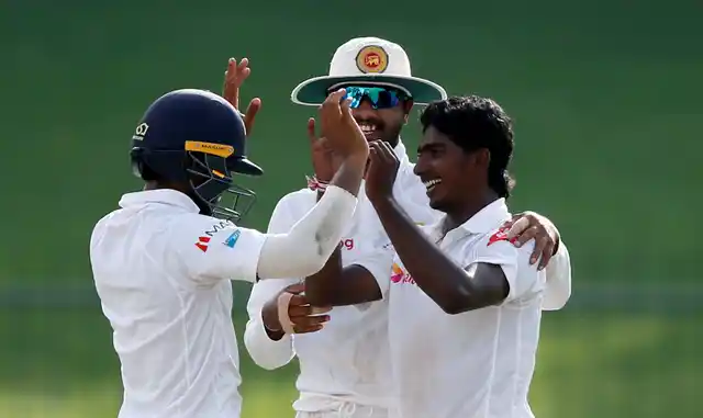 File photo of Sri Lanka’s Lakshan Sandakan celebrating a wicket with captain Dinesh Chandimal and Kusal Mendis.