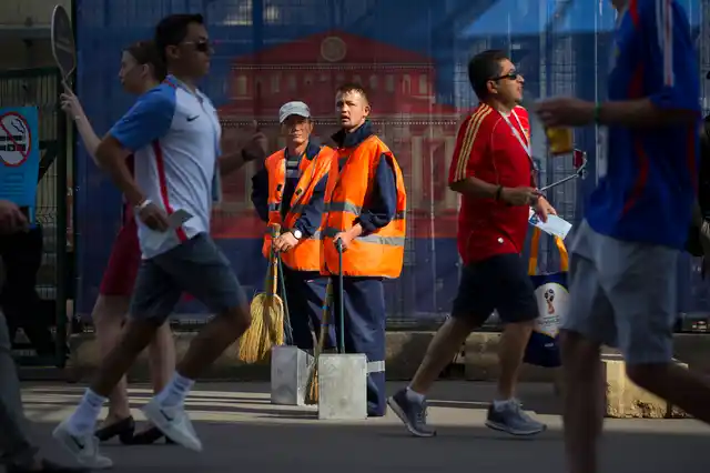 Migrant workers in orange vests are an integral part of the World Cup ecosystem