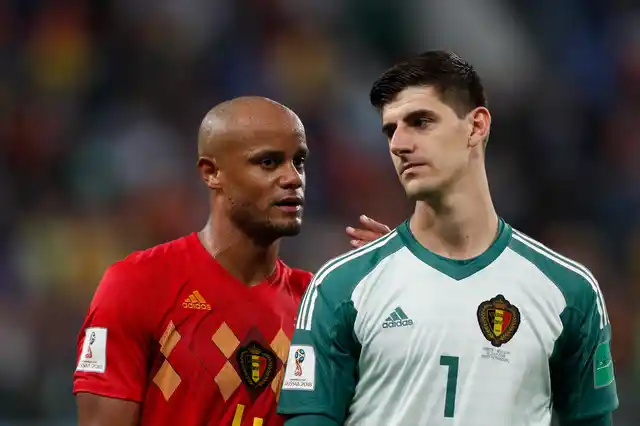 Belgium’s Vincent Kompany, left, and Belgium goalkeeper Thibaut Courtois leave the field after the semifinal match between France and Belgium at the 2018 FIFA World Cup in the St. Petersburg Stadium in, St. Petersburg, Russia