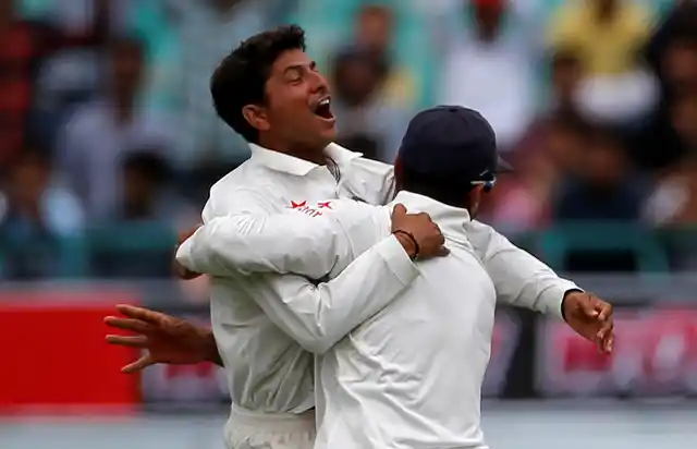 Kuldeep Yadav and Murali Vijay celebrate the dismissal of Australia’s Peter Handscomb in the former’s first Test match.