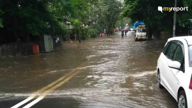 Commuters wade through the waterlogged streets on third consecutive day. 