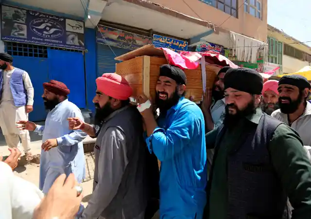 Relatives carry the dead body of the a victim of the blasts on 3 July.