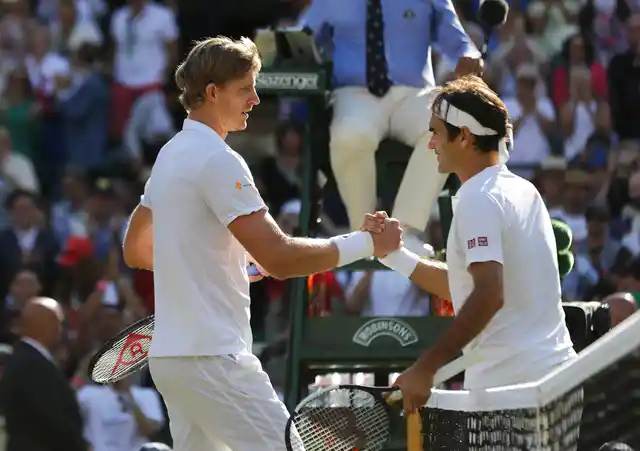 Kevin Anderson shakes hands with Roger Federer at the end of their Wimbledon quarter-final match.