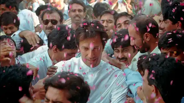File photo of supporters of former Pakistani cricketer-cum-politician Imran Khan, shower rose petals at Taxila near Islamabad.