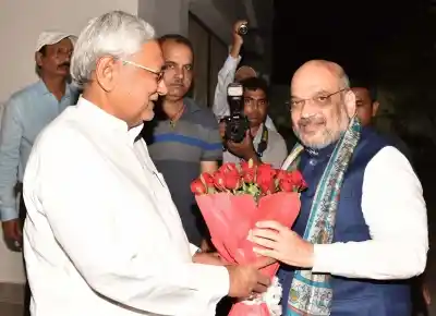 Patna: Bihar Chief Minister Nitish Kumar greets BJP Chief Amit Shah during a dinner party at his official residence in Patna on July 12, 2018. (Photo: IANS)