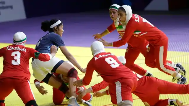 India’s Sonali Shingate gets caught between Iranian defenders.
