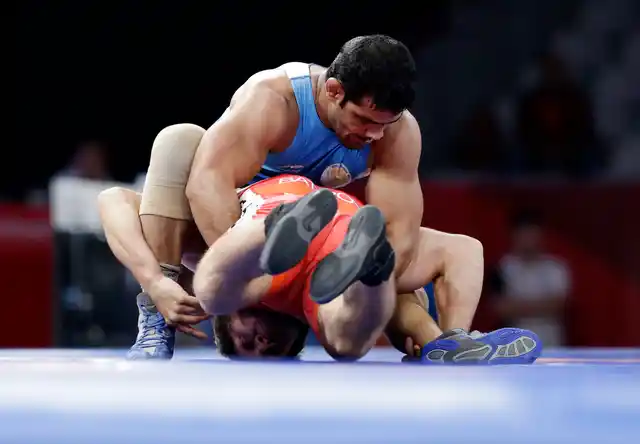 India’s Sushil Kumar in blue and Bahrain’s Adam Batirov in red compete during Men’s freestyle 74 kg wrestling at the 18th Asian Games in Jakarta, Indonesia.