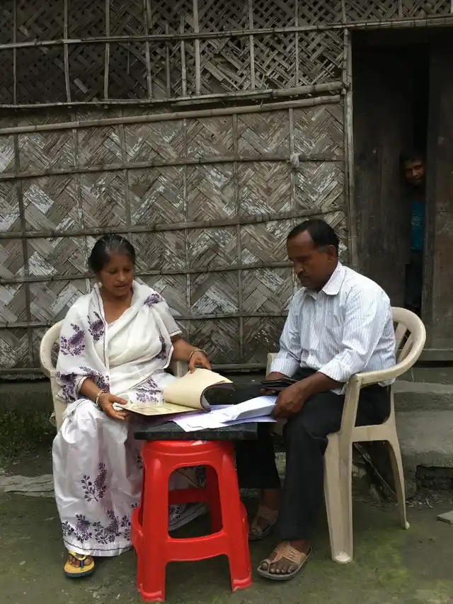 Samsul Ahmed Haque and his wife going through the documents to claim their Indian citizenship.