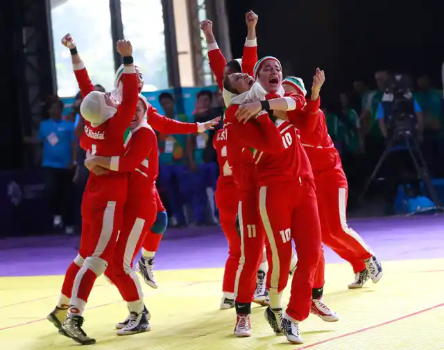 Iran’s team, in red, react after defeating India in the women’s kabaddi gold medal match at the 18th Asian Games in Jakarta, Indonesia.