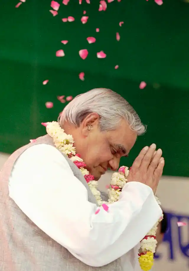 25 April, 1996 file photo, BJP candidate for Prime Minister Atal Bihari Vajpayee greets supporters and is showered with rose petals at a campaign rally.