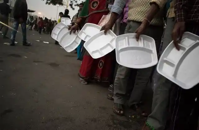 People waiting for food provided by an NGO outside AIIMS, Delhi