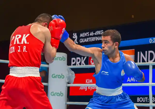 India’s Amit Panghal (Blue) and PR Korea’s Ryong Jong compete in the Men’s Light Fly (46-49kg) Quarterfinal boxing event in the 18th Asian Games 2018 in Jakarta, Indonesia.