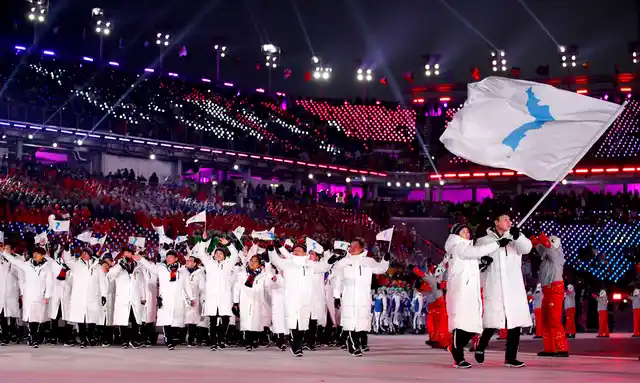 North Korea’s Hwang Chung Gum and South Korea’s Won Yun-jong carry the unification flag during the opening ceremony of the 2018 Winter Olympics in Pyeongchang, South Korea.