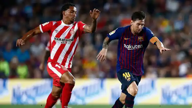 FC Barcelona’s Lionel Messi (left) duels for the ball against Girona’s Douglas Luiz during their Spanish La Liga match at the Camp Nou stadium in Barcelona on Sunday. 