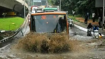 Commuters struggle through a water-logged street after rains in Bengaluru. 
