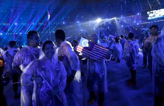 Malaysian athletes participate in the closing ceremony for the 18th Asian Games in Jakarta, Indonesia