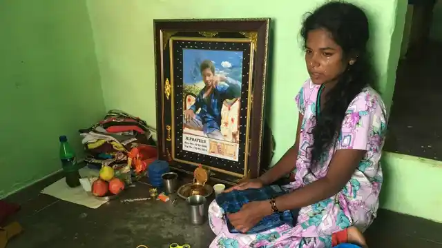 Murugamma sits beside a framed picture of her 10-year-old son Praveen, who succumbed to dog bite injuries on 1 September.