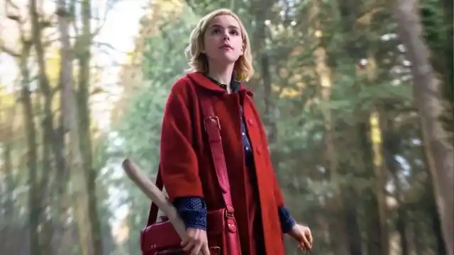 Kiernan Shipka as Sabrina Spellman in her signature red coat.
