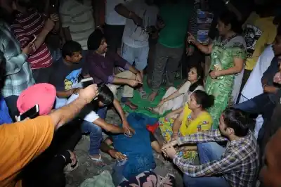 Amritsar: Grief struck relatives of those who were mowed down by a speeding train while watching Ravan Dahan standing on railway tracks in Amritsar on Oct 19, 2018. At least 30 people were killed. (Photo: IANS)
