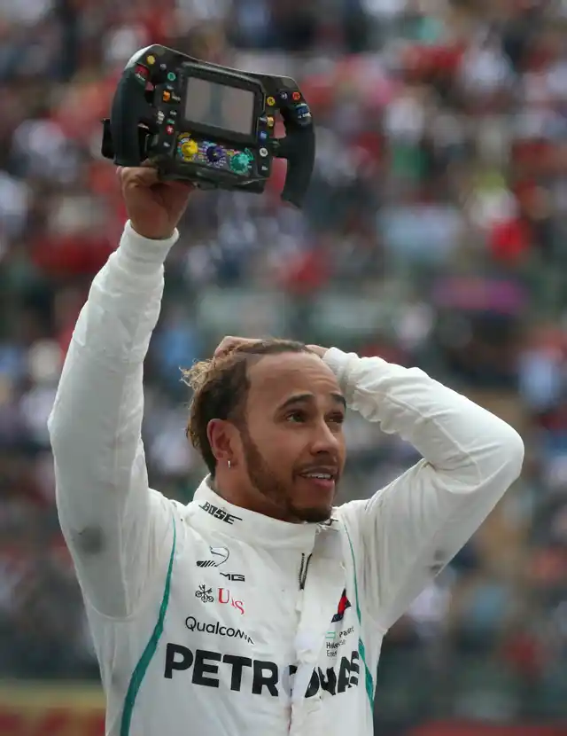 Mercedes driver Lewis Hamilton, of Britain, holds his steering wheel after becoming Formula One Champion at the Mexico Grand Prix auto race at the Hermanos Rodriguez racetrack in Mexico City, Sunday, Oct. 28, 2018.