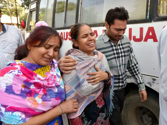 Relatives of the deceased outside the hospital.