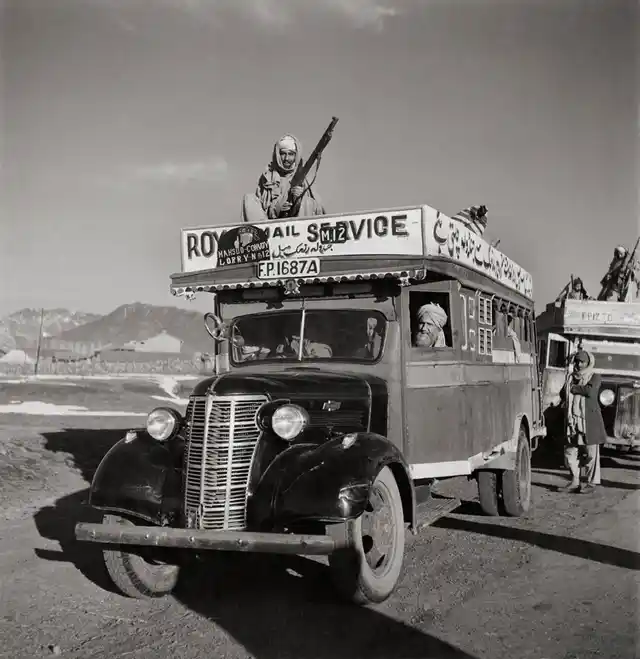 A Royal Mail bus with armed guards heads out from Razmak to Jandola in Pakistan (formerly a part of India), April 1946.