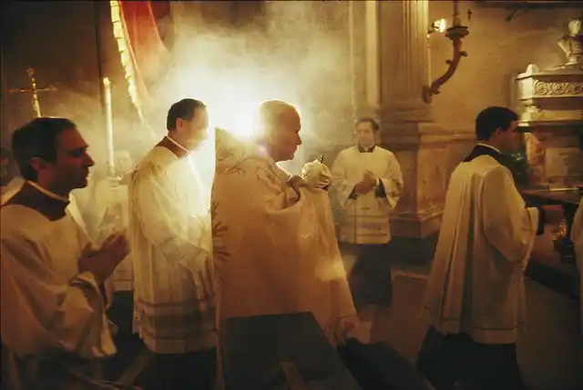 Pope John Paul II carries Holy Communion before Mass on Holy Thursday in Rome, 1985.