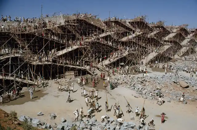 Workers swarm over scaffolding to erect the Nagarjuna Sagar dam in India, May 1963.