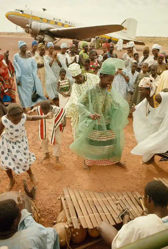 Women dance to send off a friend on an airplane trip in Mopti, Mali, 1966.