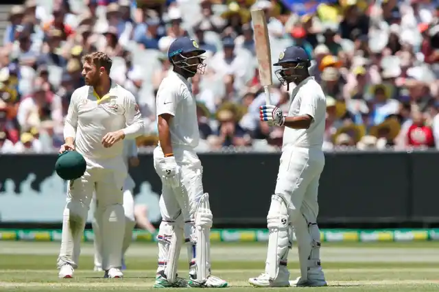 Mayank Agarwal (right) acknowledges the crowd after reaching a half century in his maiden international innings on Day 1 of the Melbourne Test.