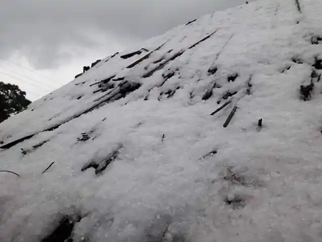The Darjeeling hills were covered with layers of snow.