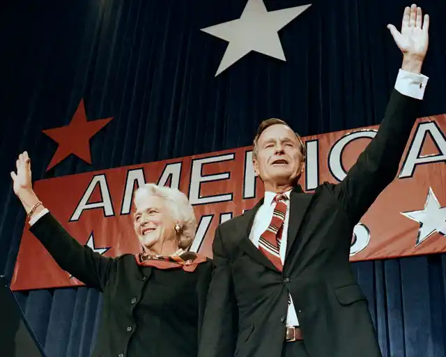 In this 1988 photo, President-elect George HW Bush and his wife Barbara wave to supporters in Houston, Texas after winning the presidential election. 