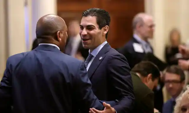 Miami Mayor Francis Suarez, right, chats with Houston Mayor Sylvester Turner during the Boston Climate Summit, 7 June 2018.