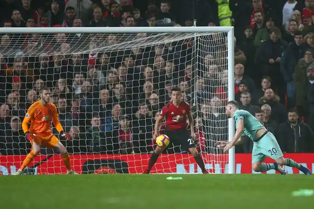 Arsenal’s Shkodran Mustafi, right, heads the ball to score his side’s first goal passing Manchester United’s goalkeeper David de Gea.