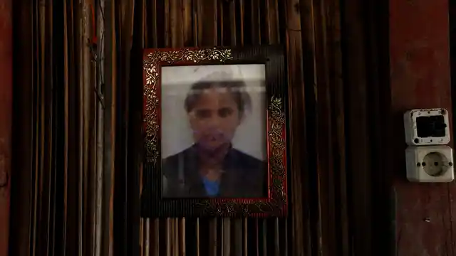 A framed photo of Adelina Sau hangs on the wall of her family’s home in Abi village in West Timor, Indonesia. 
