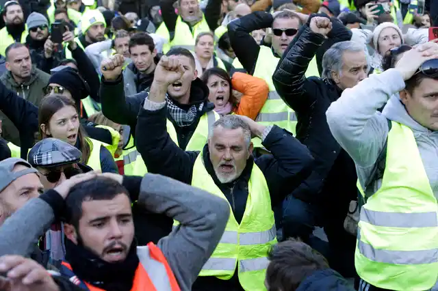 Demonstrators wearing yellow vests shout during a march Saturday, 8 December, in Marseille, southern France.