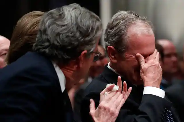 Former President George W Bush cries after speaking during the State Funeral for his father.