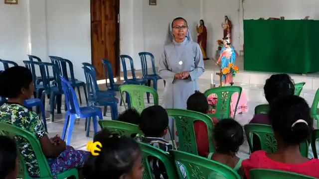 Sister Laurentina leads a prayer in a church in Fatukoko village of West Timor, Indonesia. 